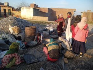 hands at work gravel sorting in community